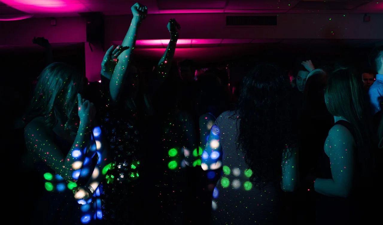 People enjoying club nightlife atmosphere with instant photo gallery